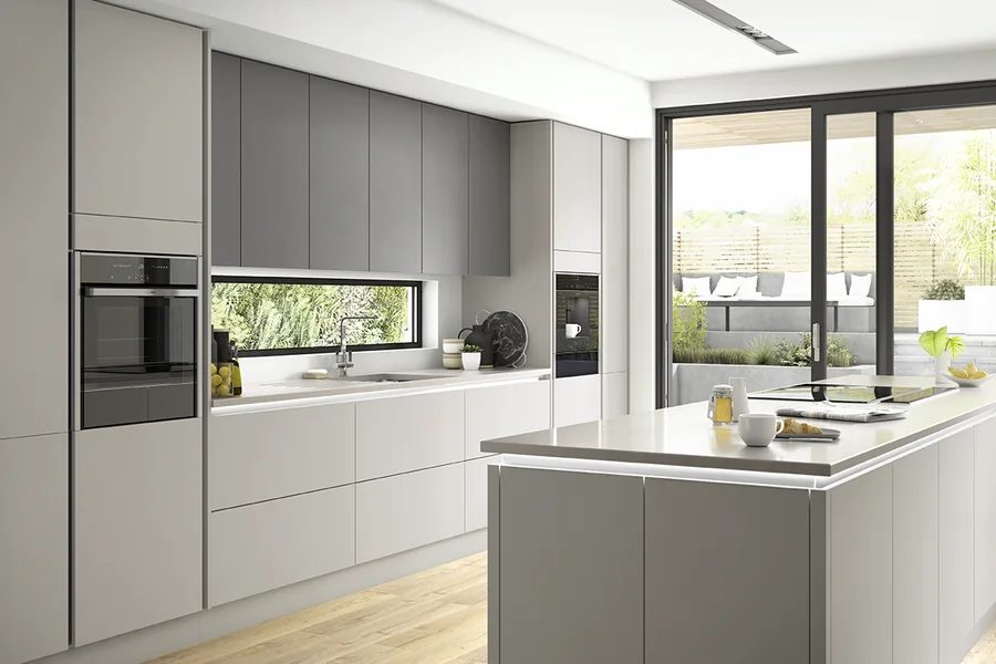 Light grey handleless kitchen with island and integrated ovens