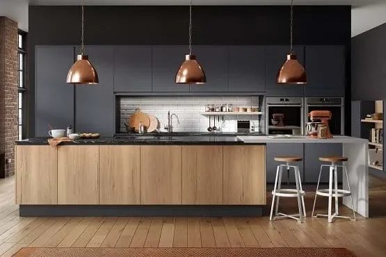 Dark grey kitchen with woodgrain island and copper pendants