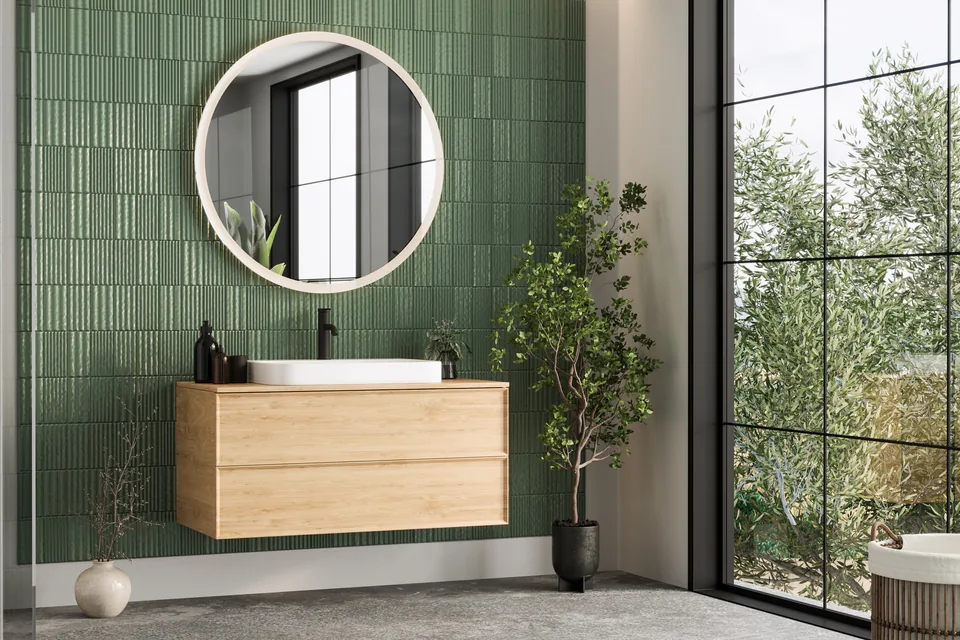 Dark green shaker kitchen with marble worktops and brass fittings